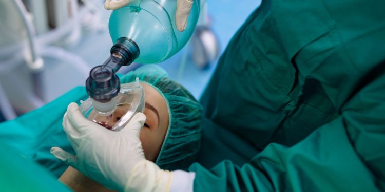 woman getting anesthesia administered