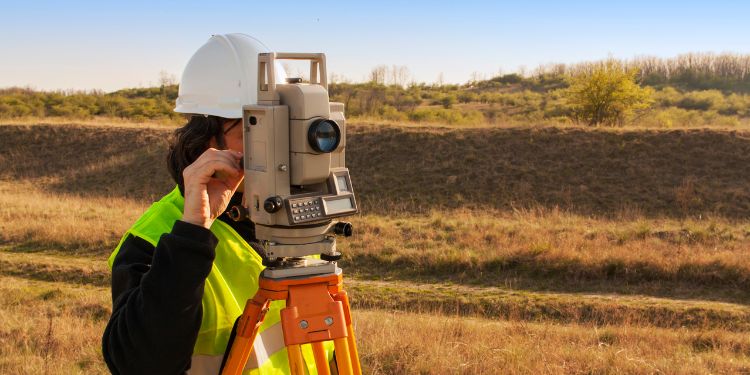 Cartographer surveying land