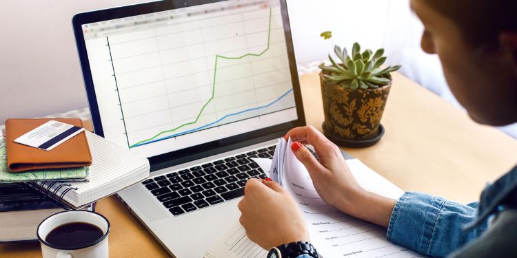 man working as an economist looking at a graph on his computer