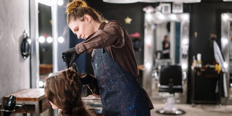 hair stylist cutting a woman's hair