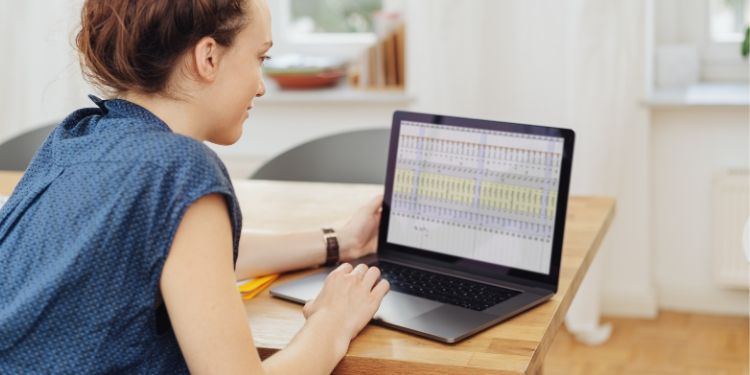 Woman looking at mathematical spreadsheets on her computer