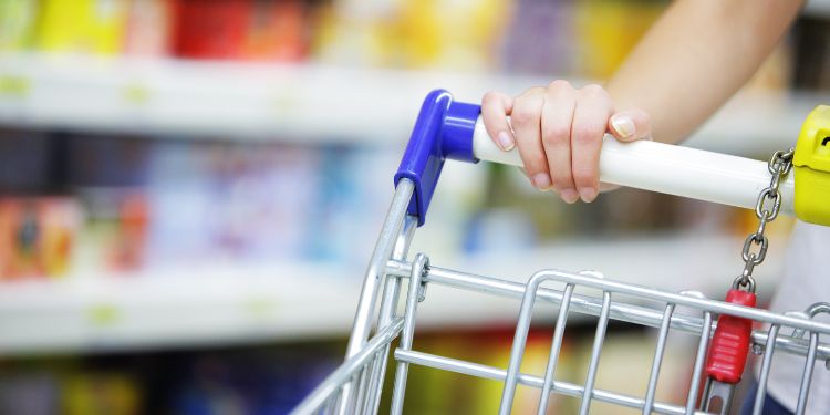 woman pushing cart while mystery shopping