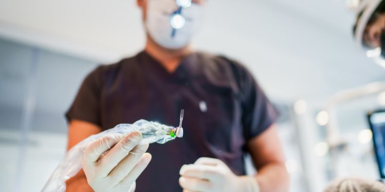 orthodontist holding up a tool