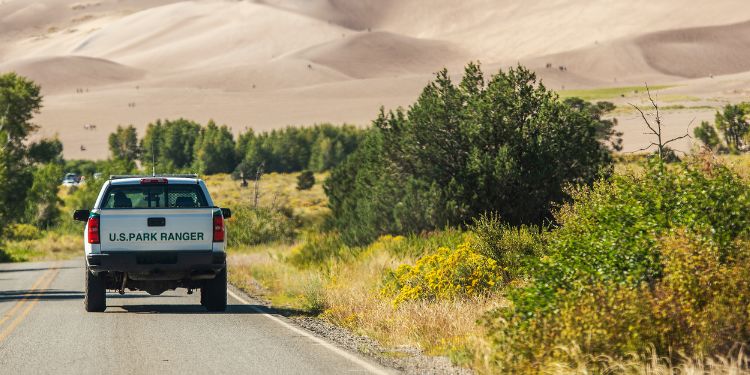 park ranger driving down the highway in an official vehicle