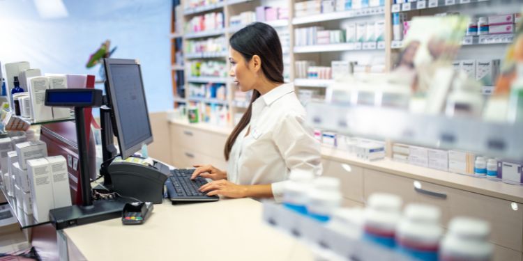 woman working behind the counter as a pharmacist