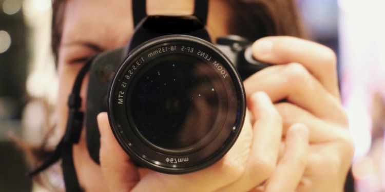 woman taking a photo behind the camera