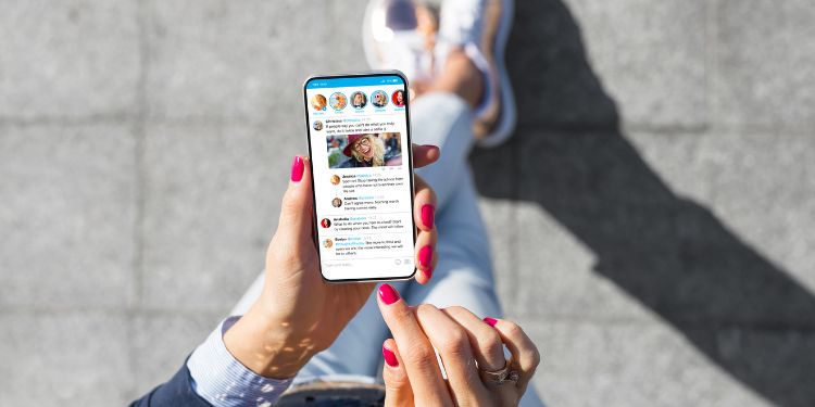 woman typing on her phone as a social media manager