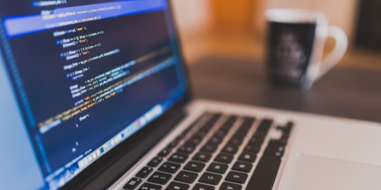 coding on a computer to represent a software developer workspace