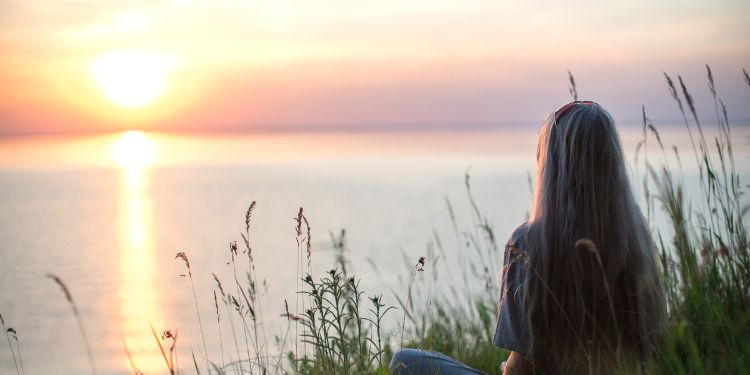 woman sitting calmly by the water